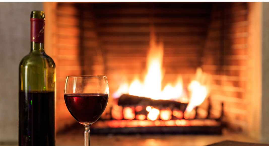Restaurants with a fireplace on the Seacoast - wine and glass in front of fire