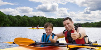 Father and Son give thumbs up on kayaks