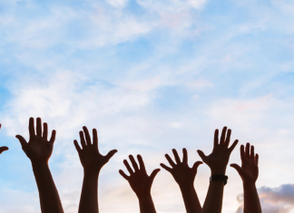 hands reaching up into the air volunteering with your kids on the Seacoast