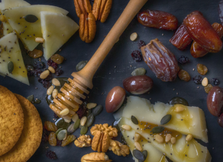 Spread of food, crackers, cheese, sesame, nuts, honey, figs. Common food allergy myths. Image from Dana Tentis/Pexels