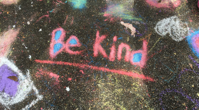 Chalk drawing on a sidewalk with the words Be Kind. November 13 is World Kindness Day