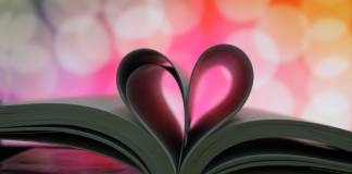 book opened with pages formed into a heart