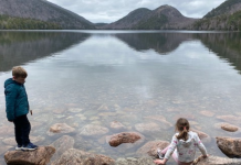 two kids on a gray day at jordan pond in acadia national park