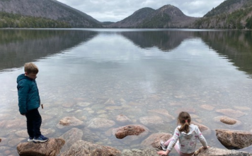 two kids on a gray day at jordan pond in acadia national park