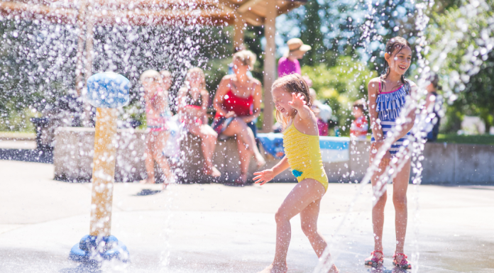 children run thorugh water features on Splash Pad