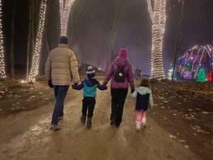 Family walks through light walk
